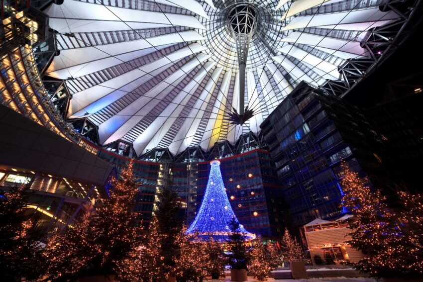 A dazzling Christmas market with bright lights and a tree made of light in Berlin, at the Sony Center