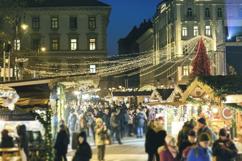 View of the Christmas Market at St Stephen's Square, with crowds and sparkling lights, at night in Budapest, Hungary