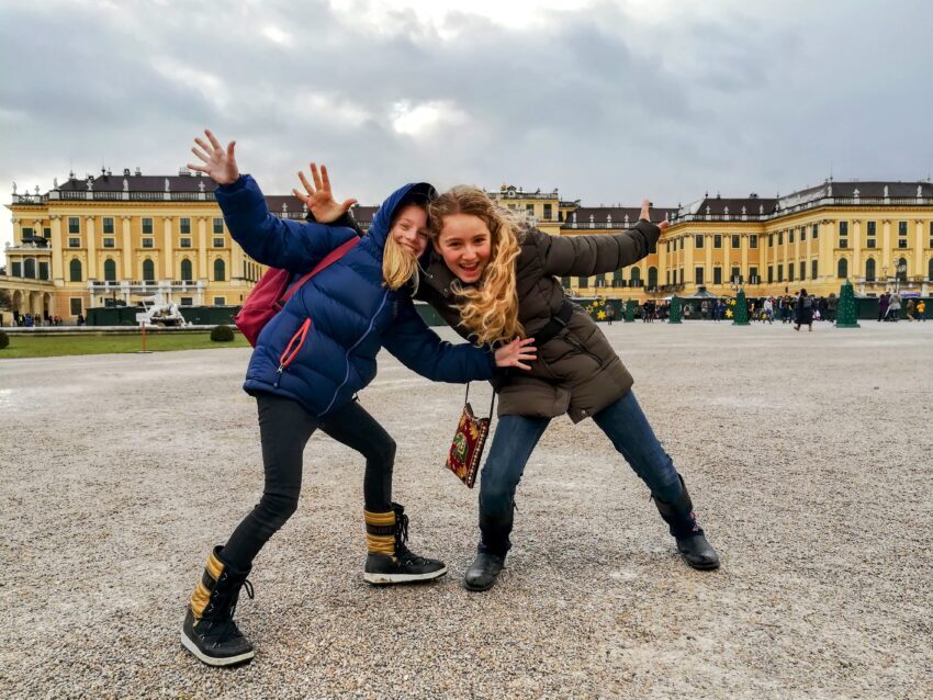 Two girls posing in front of Schonbrunn Palace, Vienna