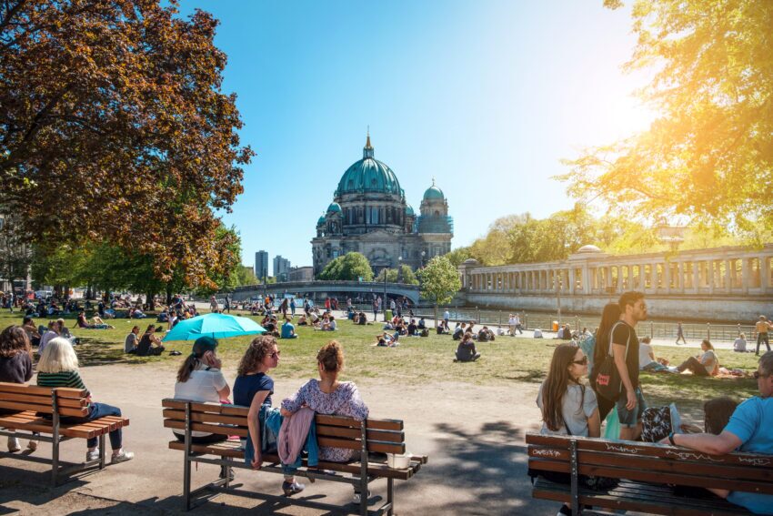 People in public park on a sunny day near Museum Island and Berlin Cathedral