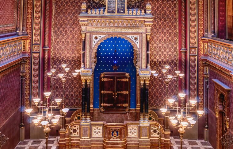 interior of synagogue with candles and red walls